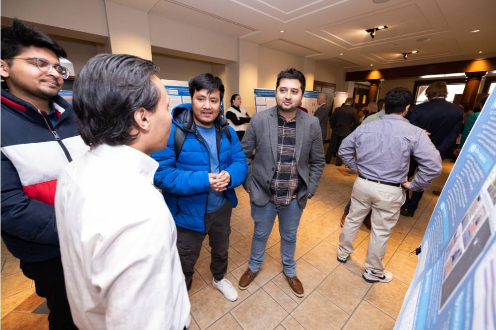 Bibash (front towards the camera/left) speaking with guests.